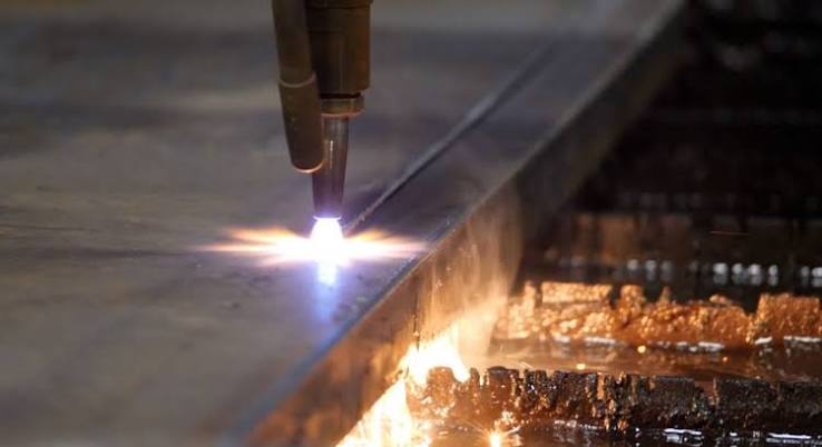 Cutting torch slicing a straight line through a thick steel plate